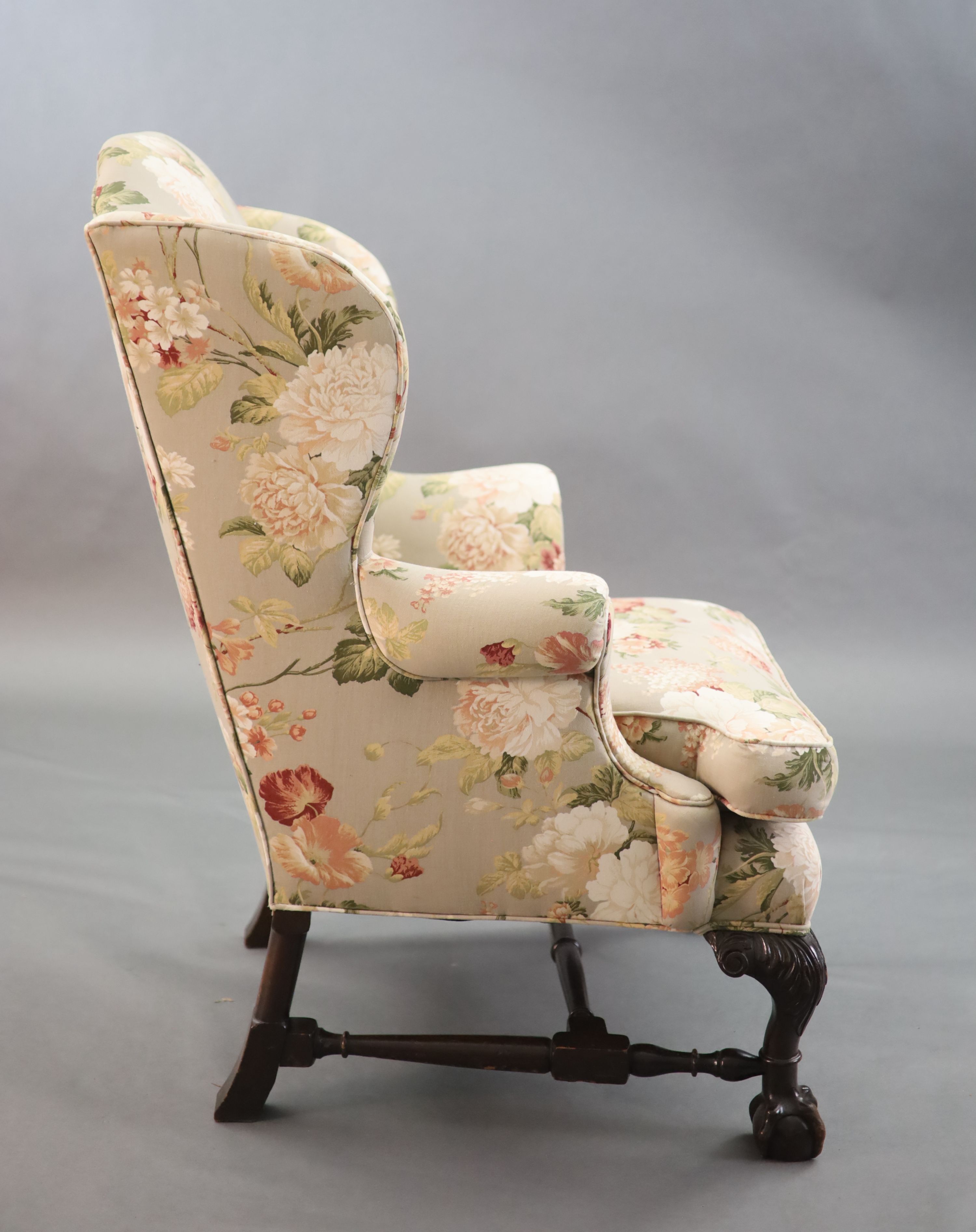 A Chippendale revival wing armchair together with a matching contemporary footstool